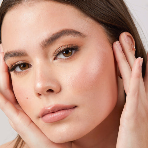 Lithe Lashes Core Collection lash style named 02 Everyday Round, an image of a model’s face wearing lithe lashes on both eyes, with full makeup, looking from a left side profile, semi zoomed in, displaying the elegance of the lashes on her eyes.