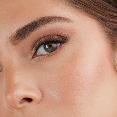 Lithe Lashes Core Collection lash style named 03 Everyday Winged, an image of a model’s face wearing lithe lashes on both eyes, with full makeup, looking from a left side profile, semi zoomed in, displaying the elegance of the lashes on her eyes.