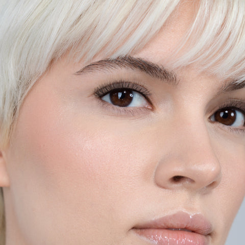 Lithe Lashes, Nude Collection, N3 Light & Feathery, an image of a model’s face wearing lithe lashes on both eyes, with full makeup, looking from a right side profile, semi zoomed in, displaying the elegance of the lashes on her eyes.