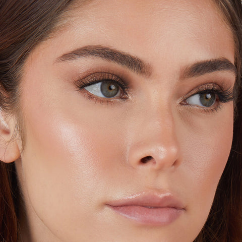Lithe Lashes Core Collection lash style named 03 Everyday Winged, an image of a model’s face wearing lithe lashes on both eyes, with full makeup, looking from a right side profile, semi zoomed in, displaying the elegance of the lashes on her eyes.