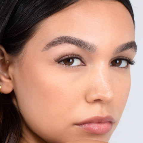 Lithe Lashes, Nude Collection, N1 Minimally Winged, an image of a model’s face wearing lithe lashes on both eyes, with full makeup, looking from a right side profile, semi zoomed in, displaying the elegance of the lashes on her eyes.