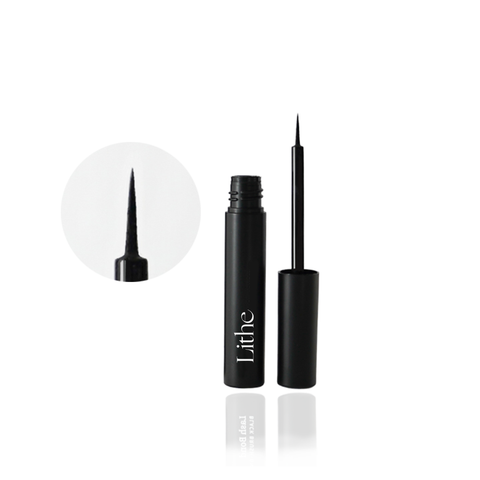Lithe Lashes false lashes accessories lash bond lash adhesive, waterproof and free of latex, parabens, phthalates, and formaldehyde. The image shows the lash glue opened with the black bottle and ultra fine tip placed side by side on a diagonal pattern on a white background