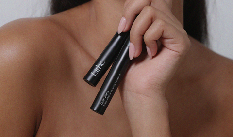 Blog_Lithe Lashes_The 4-Ingredient Lash Glue_Lash Bond_Lash glue/adhesive_Black bottle both sides shown in hand