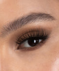 Lithe Lashes Bold Collection Style B4 - Wispy & Bold, a close up eye thumbnail image of the model's eye wearing the false lashes for an up close perspective on how elegant the falsies look on the eye.