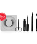 Lithe Lashes false lashes accessory, the Lithe Lash Scissors. A product image showing the Allure best of beauty seal hovering on the upper left of a pair of Core Collection lashes, and next to the lashes from left to right are the matte black Lithe Scissors, Lash Bond, Grip Liner, and Pro Lash Applicator, all floating on a white background.
