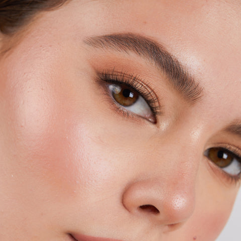 Lithe Lashes Core Collection lash style named 01 Fine and Delicate,  an image of a model’s face wearing lithe lashes on both eyes, with full makeup, looking from a right side profile, semi zoomed in, displaying the elegance of the lashes on her eyes.