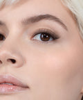 Lithe Lashes, Nude Collection, N4 - Semi Flared,  an image of a model’s face wearing lithe lashes on both eyes, with full makeup, looking from a front facing profile, semi zoomed in, displaying the elegance of the lashes on her eyes.