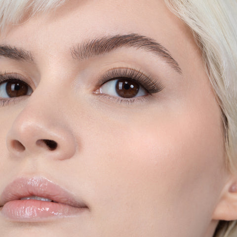 Lithe Lashes, Nude Collection, N4 - Semi Flared,  an image of a model’s face wearing lithe lashes on both eyes, with full makeup, looking from a front facing profile, semi zoomed in, displaying the elegance of the lashes on her eyes.