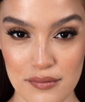 Lithe Lashes Bold Collection Style B6 - Prim & Pleated, an image of a model’s face wearing lithe lashes on both eyes, with full makeup, looking from a front facing profile, semi zoomed in, displaying the elegance of the lashes on her eyes.
