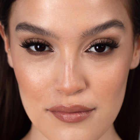 Lithe Lashes Bold Collection Style B6 - Prim & Pleated, an image of a model’s face wearing lithe lashes on both eyes, with full makeup, looking from a front facing profile, semi zoomed in, displaying the elegance of the lashes on her eyes.