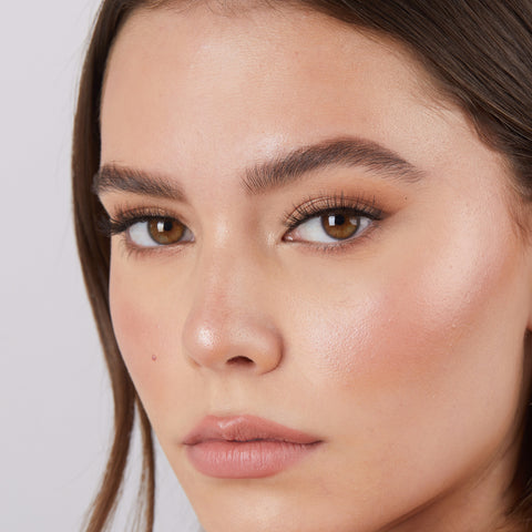 Lithe Lashes Core Collection lash style named 01 Fine and Delicate,  an image of a model’s face wearing lithe lashes on both eyes, with full makeup, looking from a left side profile, semi zoomed in, displaying the elegance of the lashes on her eyes.